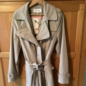 Calvin Klein feminine style trench coat with gorgeous lining and flounce hem